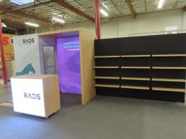 Modified ECO-2038 Sustainable Exhibit with Shelves, Locking Closet, Lightbox, SEG Fabric Graphics, Monitor Mount, and MOD-1590 Backlit Reception Counter with Locking Storage
